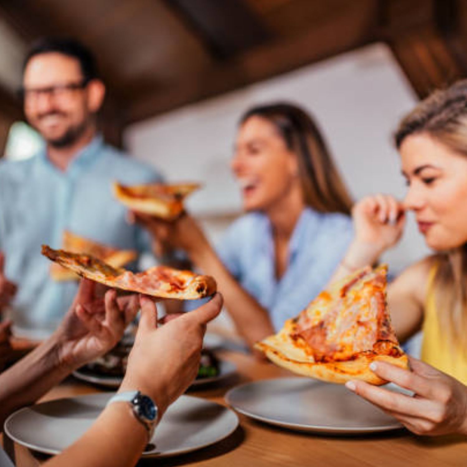 Friends sharing pizza made in a gas pizza oven — Pizza Oven Company